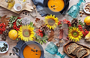 Pumpkin soup with pumpkin seeds. Table decoration for festive autumn family party.