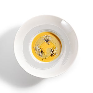 Pumpkin soup in white bowl