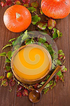 Pumpkin soup in a wooden bowl