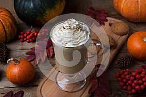 Pumpkin spice coffee latte with whipped cream and cookies