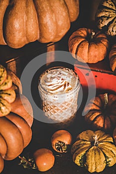 Pumpkin spice latte coffee drink topped with whipped cream