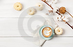 Pumpkin spice latte. Coffee top view on white wood background