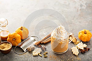 Pumpkin spice latte in a glass mug