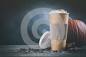 Pumpkin spice latte in a paper cup