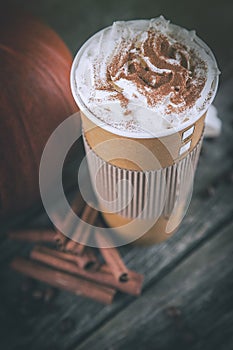 Pumpkin spice latte in a paper cup