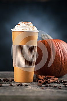 Pumpkin spice latte in a paper cup