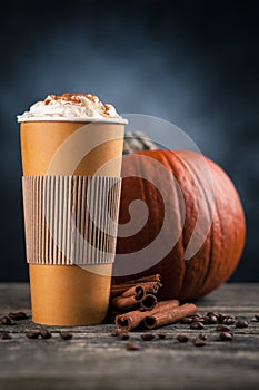 Pumpkin spice latte in a paper cup
