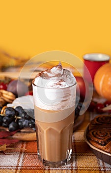 Pumpkin spice whipped latte in glasses. Hot autumn drink beverage. Nearby delicious pie and appetizers fruits and cheese