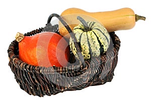 Wicker basket of cucurbitaceae in closeup on white background