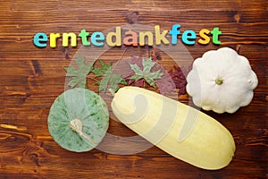 Pumpkin squash, vintage text Erntedankfest, Thanksgiving. Top view, wooden background