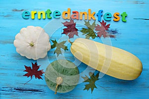 Pumpkin squash, vintage text Erntedankfest, Thanksgiving. Top view, wooden background