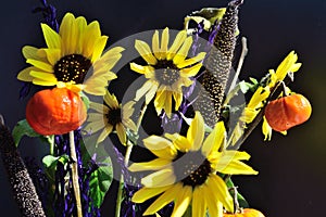 Pumpkin on a stick sunflower millet grass purple filler autumn bouquet closeup horizontal