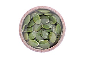 Pumpkin unshelled seeds in wooden bowl