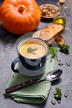 Pumpking soup in a mug, fresh autumn hot soup