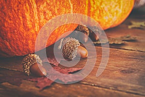 Pumpkins and autumn leaves on wooden background. thanksgiving and halloween concept.