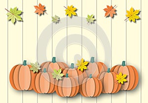 Pumpkins with colourful leaves on pastel wood background. Autumn or Thanksgiving and Halloween concept.