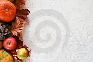 Pumpkins, fruits and autumn maple leaves. Copy space. Autumn seasonal harvest concept.