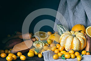 Pumpkins, Kumquats, Orange, Sweet Potato, Carrot, Autumn Composition on Dark Wooden Background, Toned Picture