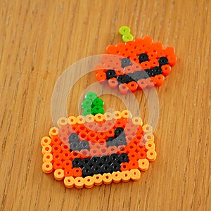 Pumpkins made of plastic beads on table