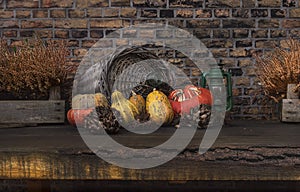 Pumpkins on  old wooden table against the background of an old brick wall