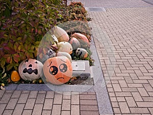 Pumpkins with painted faces and roads taken from a distance.