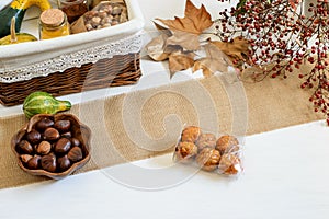 Pumpkins, spices, chestnuts and panelles de piÃÂ±ones prepared for packing in gift basket. Halloween festive emotions, autumn