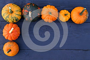 Pumpkins and squashes varieties on wooden background