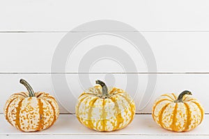 Pumpkins on wooden background