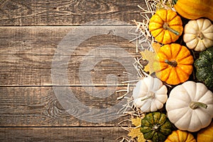 Pumpkins on wooden background, top view