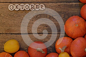 Pumpkins on wooden planks with word OKTOBER