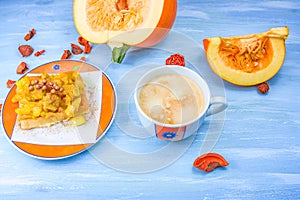 Pumpkin or melon on a table with a cup of coffee