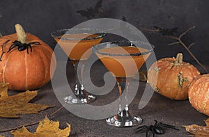 Pumpkintini pumpkin martini coctail with black sugar rim for Halloween parties or Thanksgiving Day