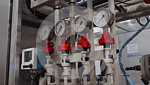 Pumps, pipelines and devices in an interior of modern boiler house, manometers, pipes and faucet valves of gas heating