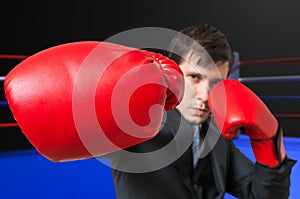 Punch of boxing businessman in suit. Fighting concept