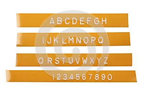 Punch letter alphabet on orange labeling tape