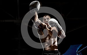 Punching boxer on boxing ring