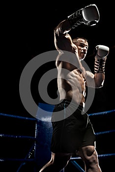 Punching boxer on boxing ring