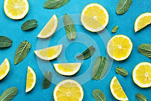 Punchy pastel background with lemon slices and mint leaves. Summer colorful pattern. Flat lay style.
