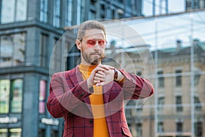 punctual man in jacket and glasses check time outdoor. punctual man check time in the street.