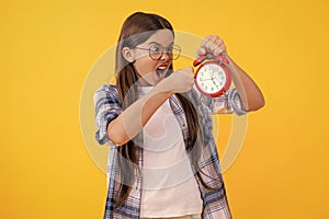 punctuality in early morning time. school time schedule. teen girl with alarm clock. Time ticking for a busy teen girl