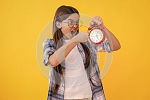 punctuality in early morning time. school time schedule. teen girl with alarm clock. Time ticking for a busy teen girl photo