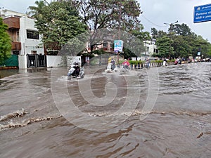 PUNE, Maharashtra, 03 Dec 2021, Peoples drive through waterlogged during heavy rain at BT Kawde Road in Pune. D, flooded roads