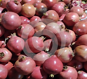 Punica granatumJuicy sweet ripe red summer autumn pomegranate fruit ondark background