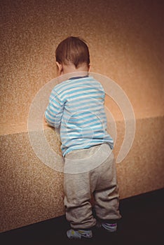 Punished a child standing at the wall