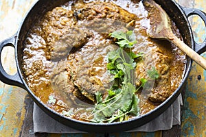 Punjabi chicken curry with coriander. Classic indian masala.