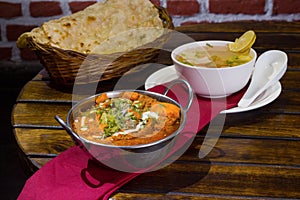 Punjabi cuisine paneer butter masala, clear veg soup, butter naan