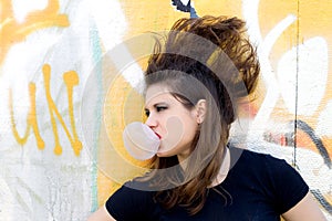 Punk girl blowing bubble gum