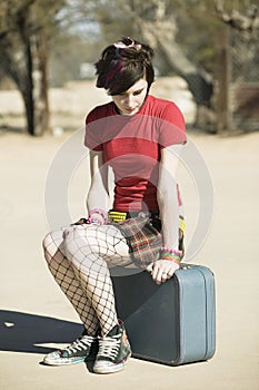 Punk Girl Sitting on Suitcase