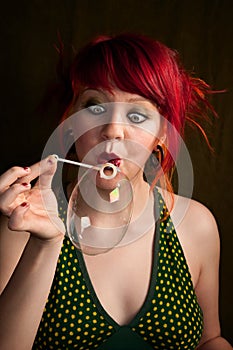 Punky Girl with Red Hair Trying to Blow a Bubble