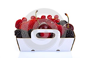 Punnet of fresh red summer fruits photo